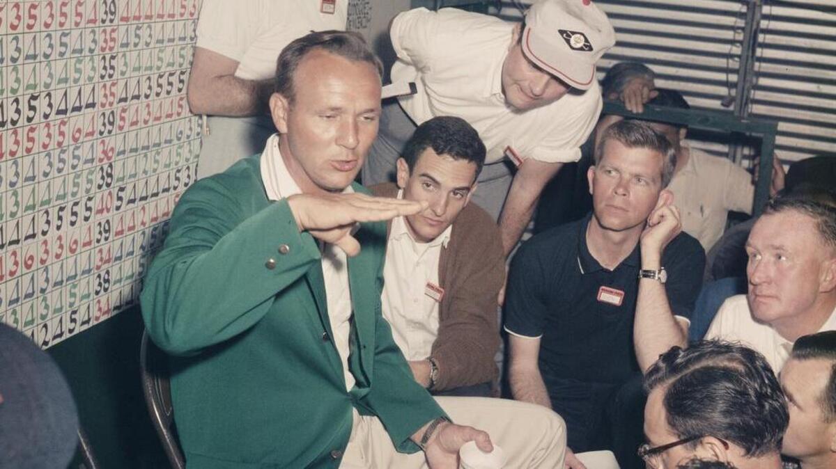 Arnold Palmer talks to the media, including Ron Green Sr. (second person seated to Palmer’s left in dark shirt) during an interview after winning the 1962 Masters.