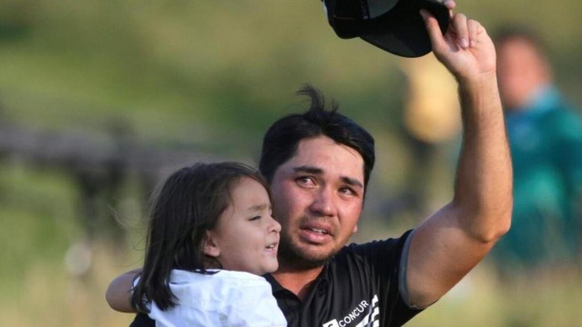 
Jason Day, of Australia, holds his son Dash as he walks off the 18th green after winning the PGA Championship golf tournament Sunday, Aug. 16, 2015, at Whistling Straits in Haven, Wis. (AP Photo/Jae Hong)
