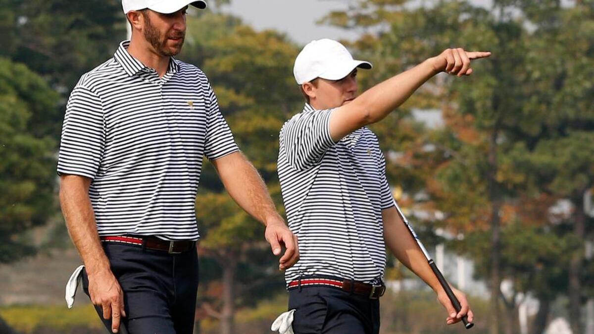 
United States' Jordan Spieth, right, gestures as he walks a fairway with teammate Dustin Johnson during their final practice round ahead of the Presidents Cup golf tournament at the Jack Nicklaus Golf Club Korea, in Incheon, South Korea, Wednesday, Oct. 7, 2015. 
