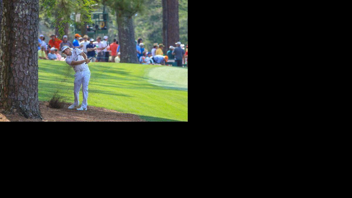 
Russell Henley hits his second shot on the 13th hole during the first round of the 2015 Masters golf tournament, Thursday April 09, 2015, in Augusta, Ga. 
