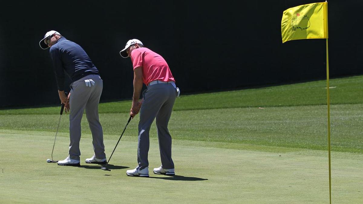 Adam Scott and Jason Day practice some putts on No. 5 during Tuesday's practice round of the 2016 Masters at Augusta National Golf Club in Augusta, Ga.