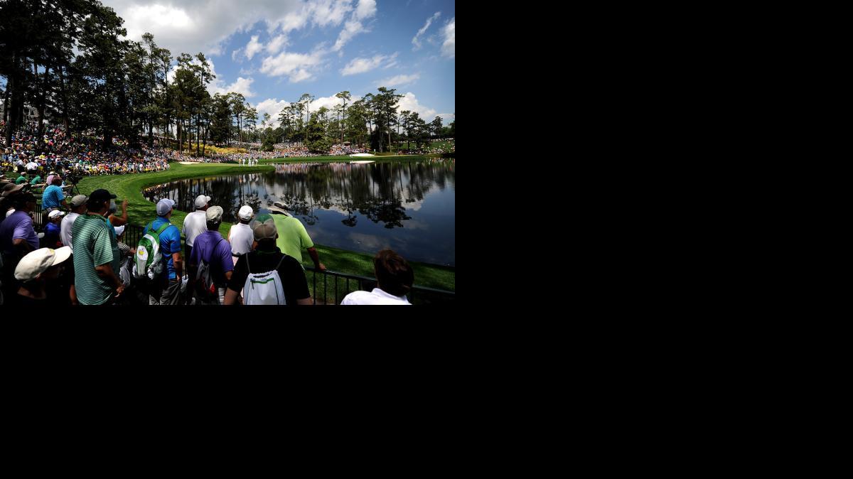 
Golf fans line the railing and hillside near the ninth green during the Par 3 contest on Wednesday, April 8, 2015, at Augusta National Golf Club in Augusta, Ga. 
