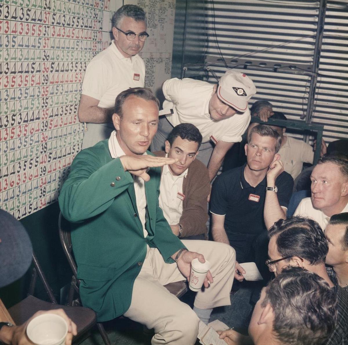Arnold Palmer talks to the media, including Ron Green Sr. (second person seated to Palmer’s left, wearing dark shirt) during an interview after winning the 1962 Masters.