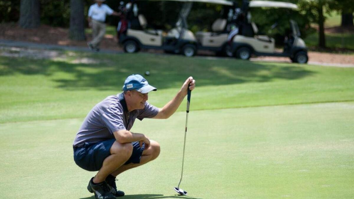 Paul Sanderson lines up a putt during the Columbia Amateur Golf Tournament at Wildewood Country Club.