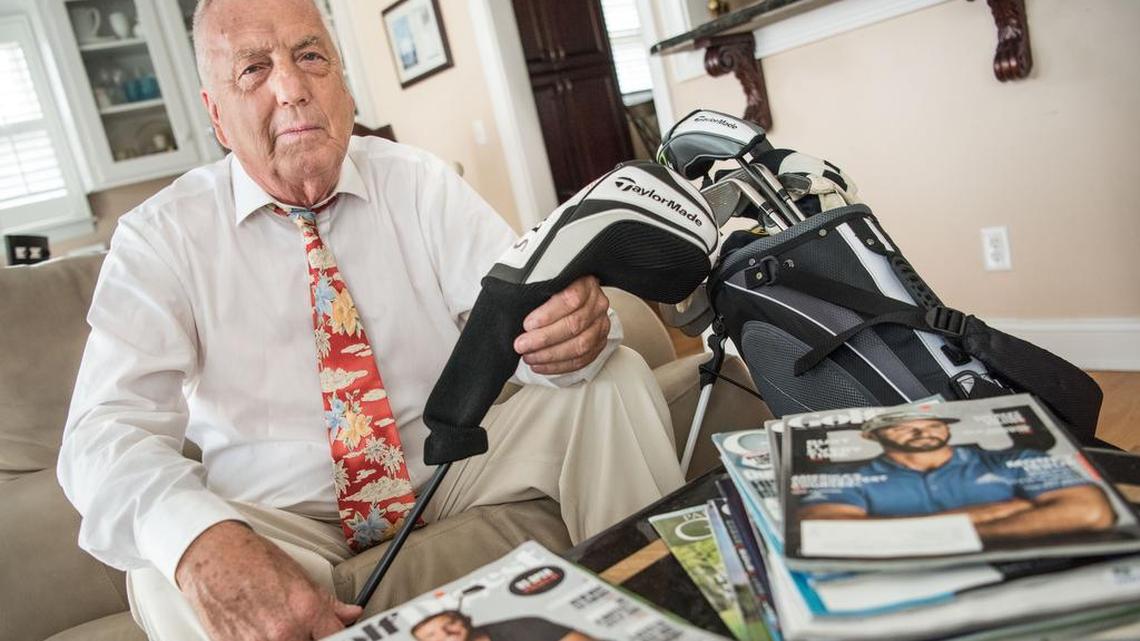 Art Whisnant, grandfather of professional golfer Dustin Johnson, poses for a photo with a set of clubs given to him by his grandson, at his Lake Murray home Tuesday.