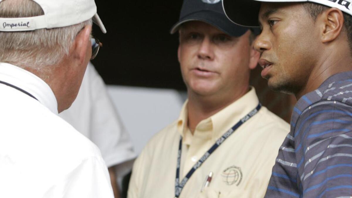 PGA tournament official Dillard Pruitt, center, listens to another official as Tiger Woods waits for a ruling in an earlier tournament. Pruitt is on his way to the South Carolina Golf Hall of Fame.