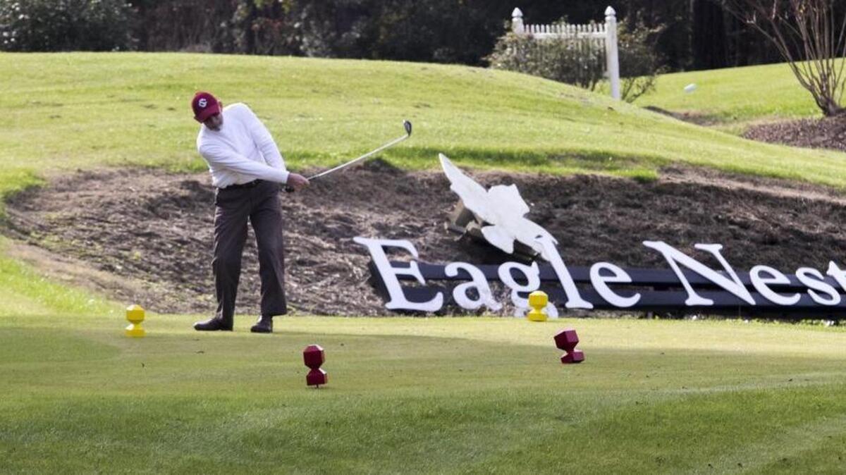 A golfer tees off on the 18th hole at Eagle Nest in Little River.