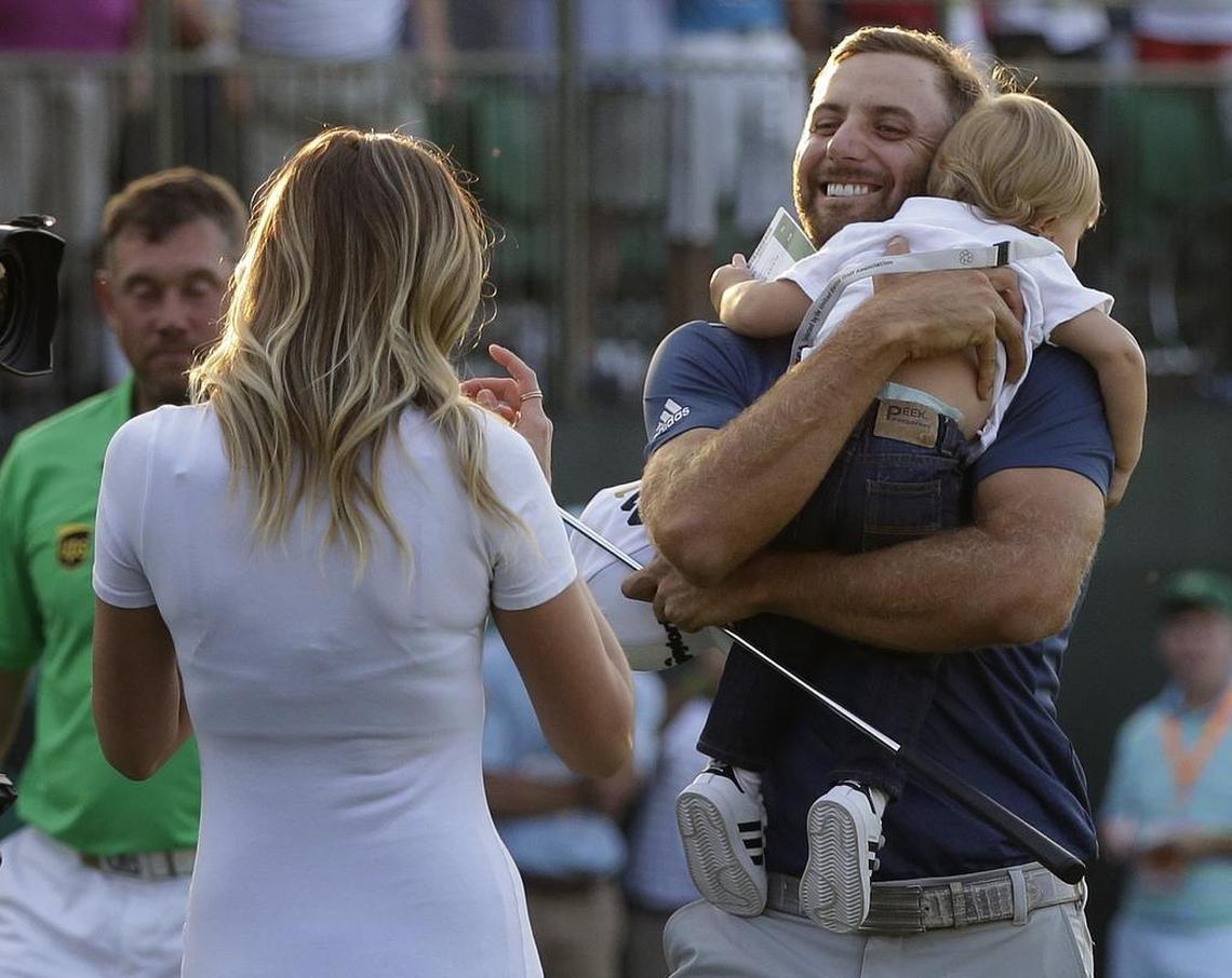 Dustin Johnson, right, greets his fiancé Paulina Gretzky as he holds their son Tatum Gretzky on the 18th hole during the final round of the U.S. Open golf championship at Oakmont Country Club on June 19, 2016, in Oakmont, Pa.