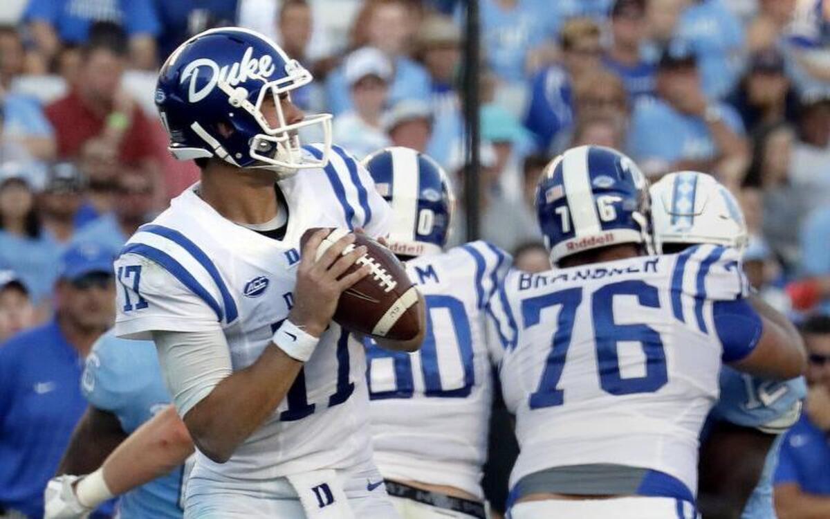 Daniel Jones, left, goes to make a pass behind the block of Gabe Brandner, 76, during Duke’s win at UNC on Sept. 23. Brandner suffered a hamstring injury against Virginia on Oct. 7 and may not play against Florida State on Oct. 14.
