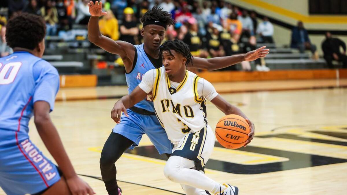 Irmo Yellowjackets guard Dylan Williams (3) drives past A.C. Flora Falcons guard Adonis McDaniel during their game at Irmo High School Friday evening, January 14, 2022.