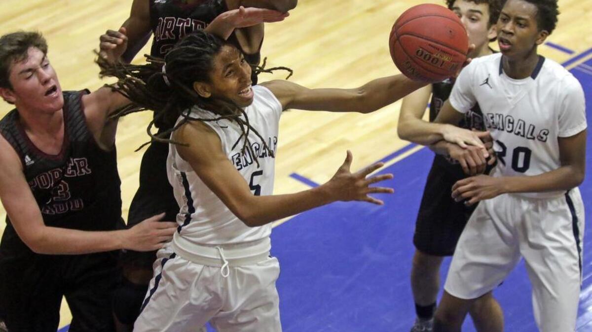 Blythewood basketball's Josh Bowers (5) drives against Porter Gaud defenders Wednesday at the Chick-fil-A Classic at Richland Northeast High.