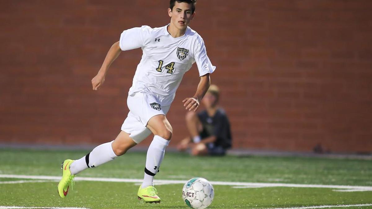 River Bluff’s Connor Deany dribbles the ball upfield.