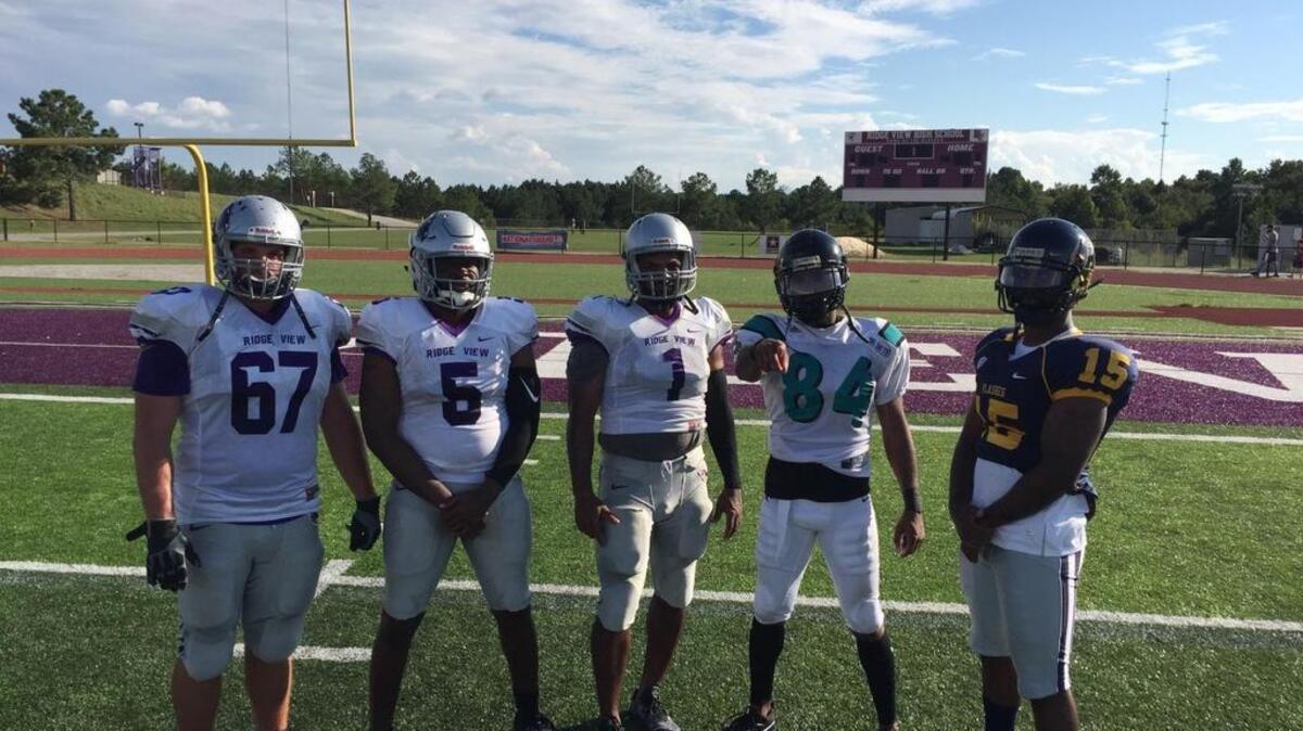 Ridge View High coach Perry Parks (84), and his assistants, fulfilled a promise to dress in full gear for a practice after his squad started the with a 5-0 record.