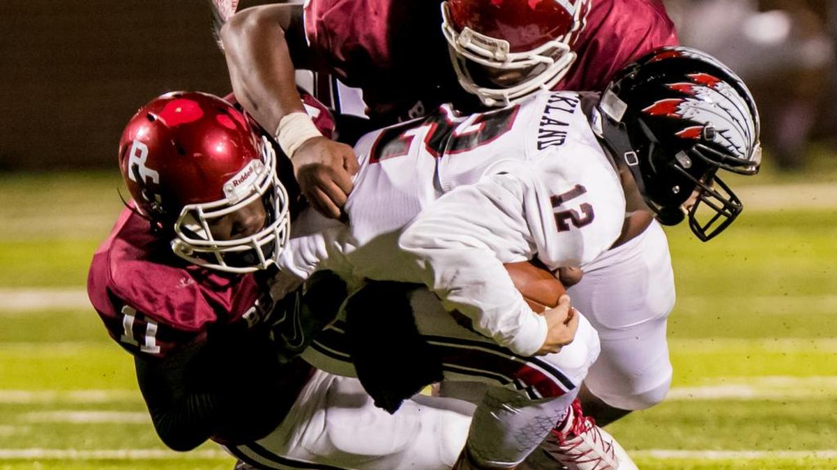 Brookland-Cayce’s Cam Brown (11) and Travis Loadholt (55) sack Gilbert Indians quarterback Josh Strickland (12) during a game last season. The two teams meet in a key Region 5-3A game Friday in Gilbert.