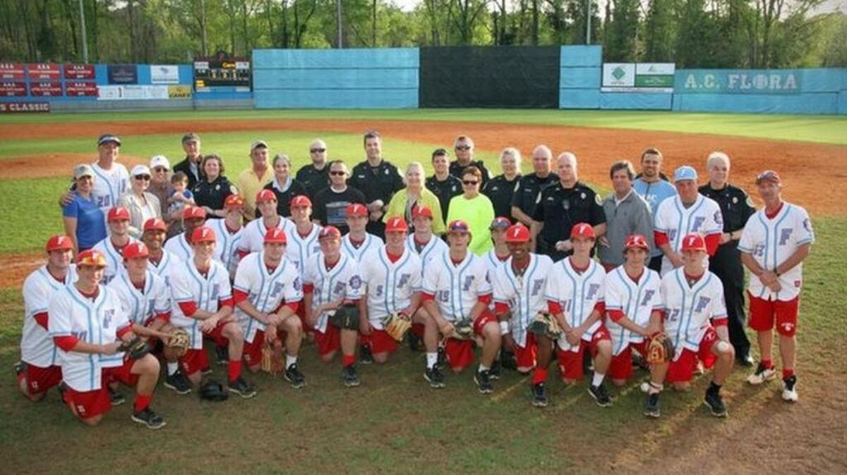 Players and police officers at Forest Acres Classic.