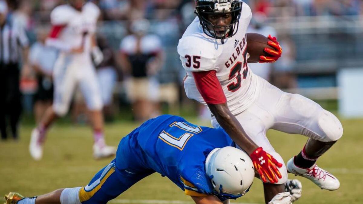 Gilbert running back Catriez Cook is upended by Lexington's Drew Richardson during the jamboree at White Knoll High School this past Friday.