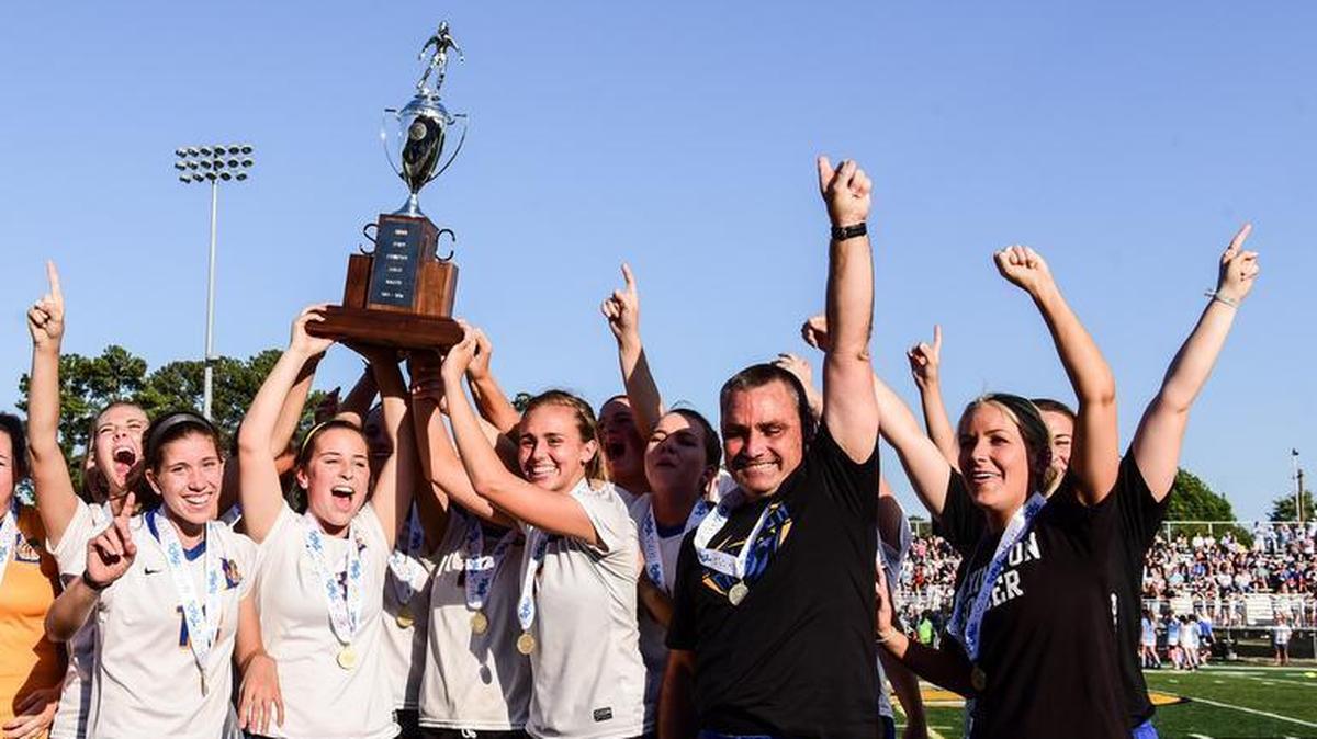 Chris Fryland (second from right) and the Lexington girls soccer team after their 2016 state championship win.