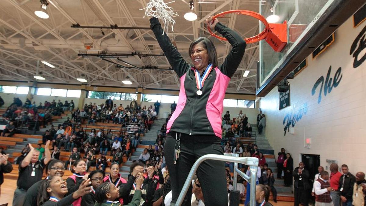 Lower Richland girls basketball coach Debbie Stroman cuts down the net during a pep rally to recognize the 3A state championship team 2013. Stroman was named the athletic director at LR this week.