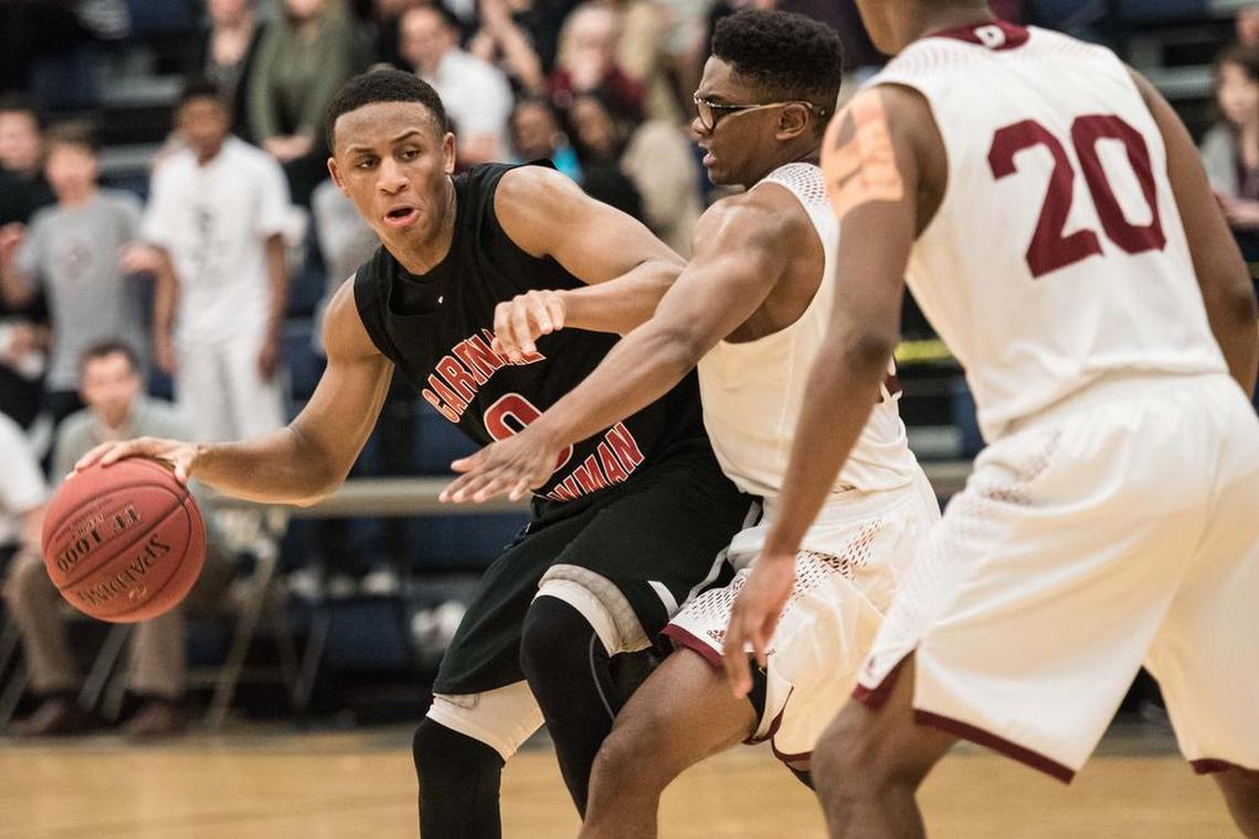 Cardinal Newman's Brandon Martin dribbles the ball against Porter Gaud's Dante Smith during the SCISA Class 3A state championship game Saturday, February 25, 2017 in Sumter, SC. Martin signed to play at USC Upstate.
