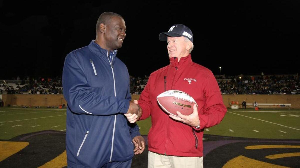 South Carolina High School Commissioner of Officials Bruce Hulion, right, receives a football from SCHSL commissioner Jerome Singleton for his years of service with the league. Hulion is retiring this week after 16 1/2 years with the SCHSL.