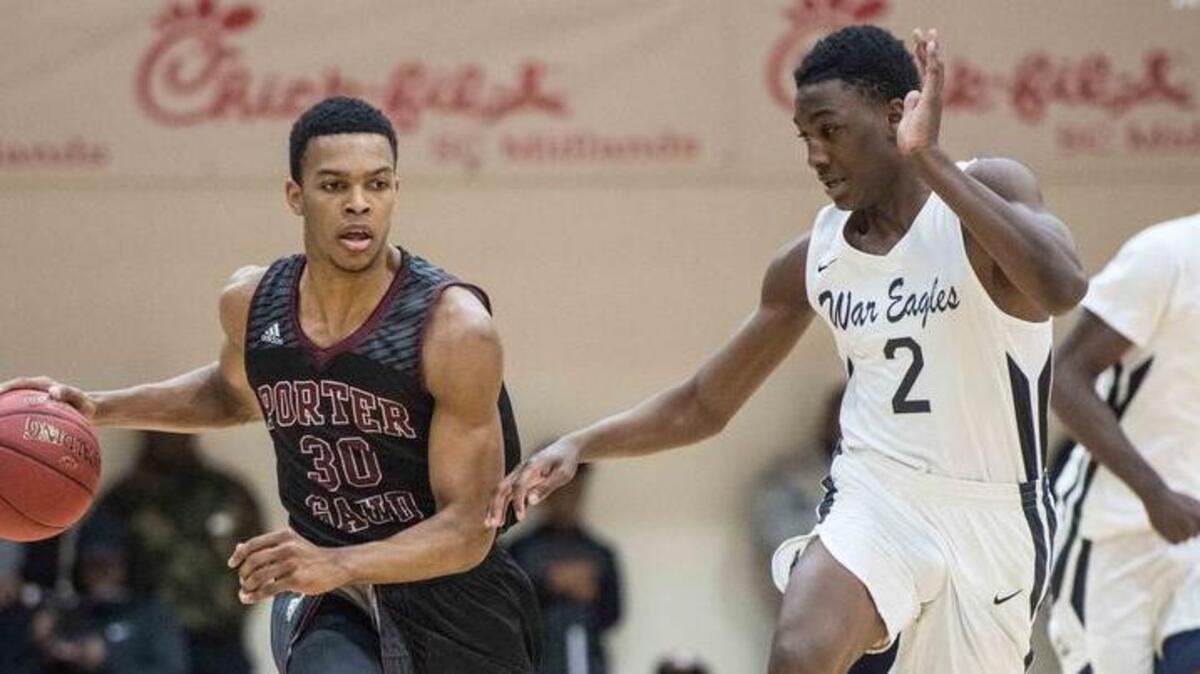 Porter-Gaud guard Josiah James (30) dribbles the ball against Gray Collegiate forward Ty Rivers (2) during the Chick-fil-A Classic at Richland Northeast on Dec. 22. The Chick-fil-A Classic will begin after Christmas for the first time in tournament history.