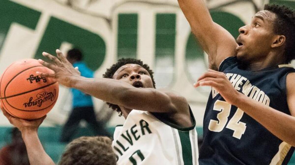 Jordan Davis of Dutch Fork attempts a shot over Trae Churn of Blythewood Friday night at Dutch Fork High School in Irmo, S.C. Blythewood defeated Dutch Fork 83-54.