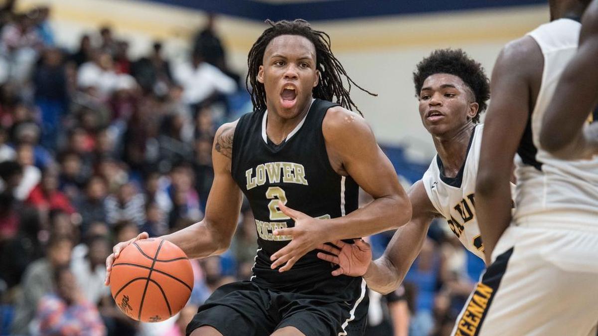 Lower Richland star Christian Brown (2) drives to the hoop against Q'dardruis Sanders (3) at Keenan High School on Friday.