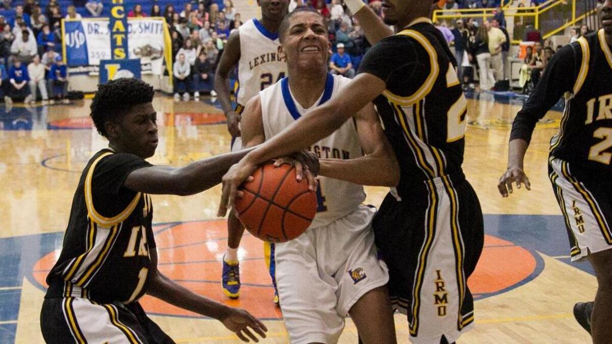 Irmo's Tavonne Bond (11) and Ronnie Jamison (21) knock the ball from Lexington's Caleb Shackleford (4)