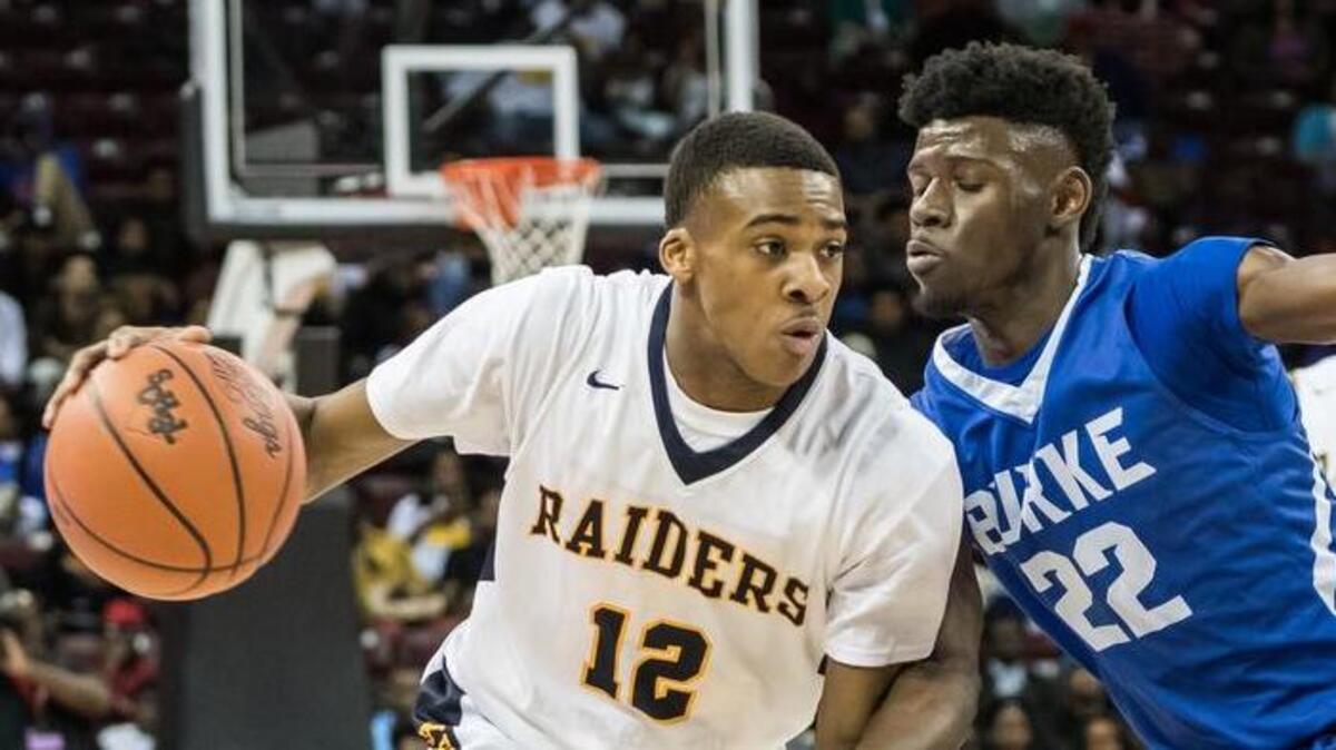 Keenan's Latrell Taylor (12) drives to the basket as Burke's Anthony Hill (22) defends during their Class 2A Boys State Championship. Keenan begins season ranked No. 1 in the The State’s Boys Preseason High School Basketball poll.