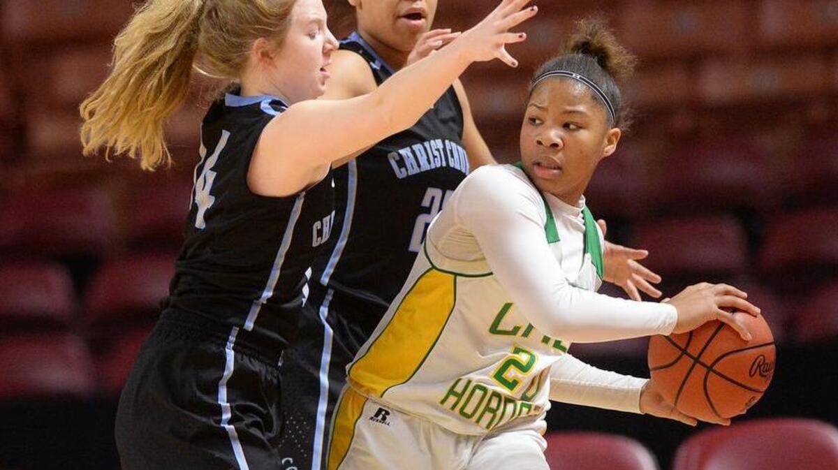 Christ Church's Paula Pieper (15), left, and Christ Church's Lawren Cook (23) guard C.A. Johnson's Demeatrius Bryant (20) during the Class A girls Upper State finals on Saturday at Bon Secours Wellness Arena in downtown Greenville.