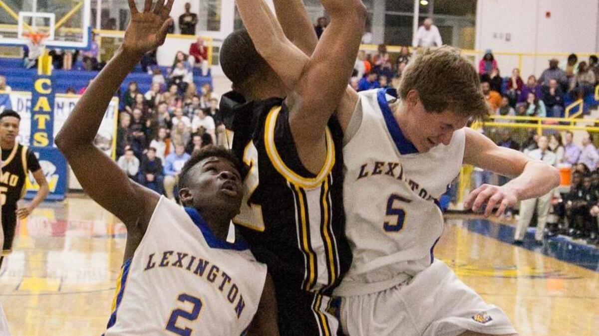 Lexington’s Montreal Schuler and Spencer Bethea (5) battle Irmo’s Winston Hill under the basket during Friday night’s game.