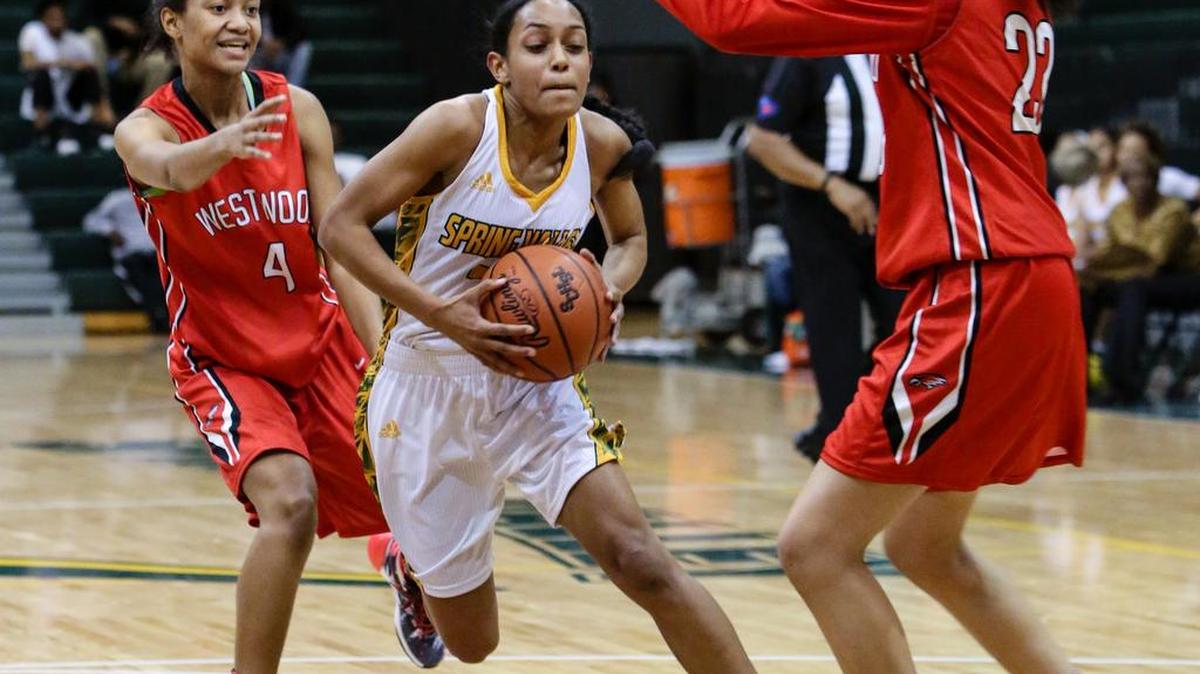 Spring Valley's Dominique Hill maneuvers through Westwood defenders Essence Marshall (4) and Mya Belton during a game Monday night at Spring Valley.