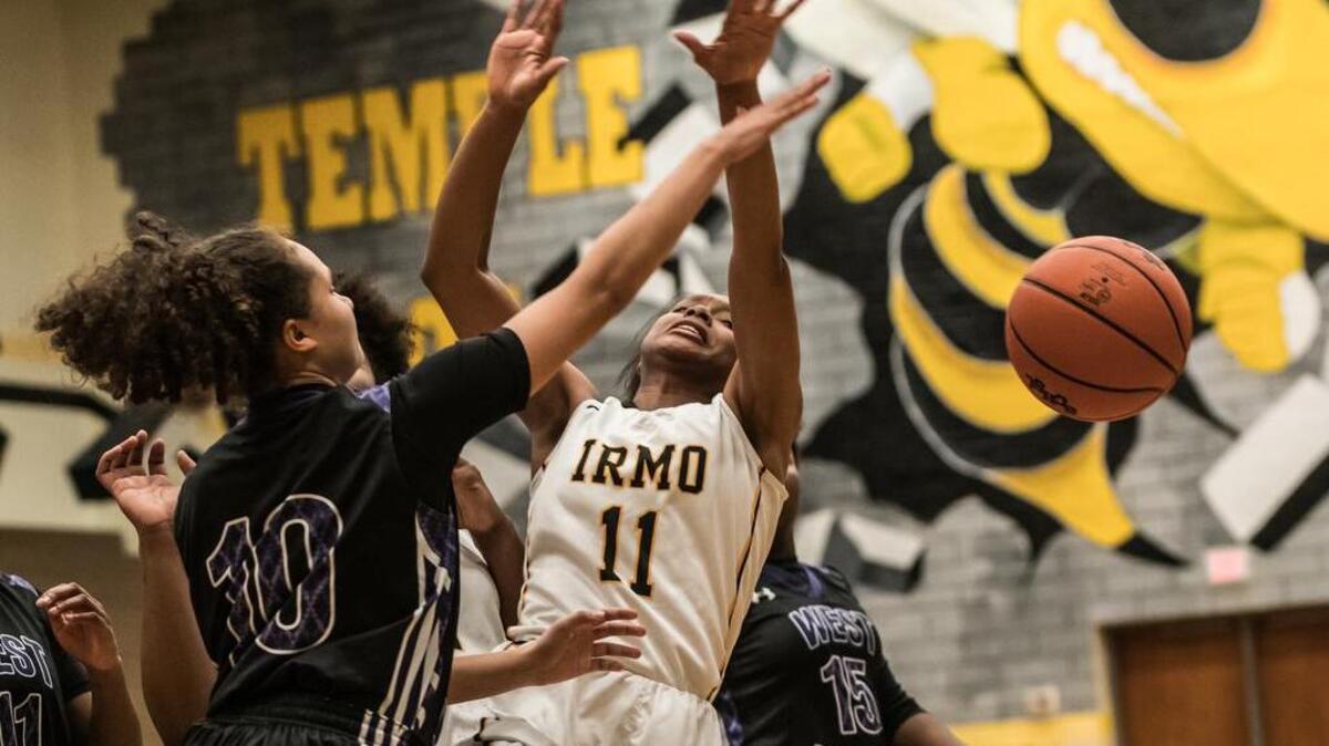 West Ashley's Kaleis Spaulding (10) knocks the ball from Irmo's Taiylar Demoss' (11) control during their first-round 5A playoff game on Tuesday.