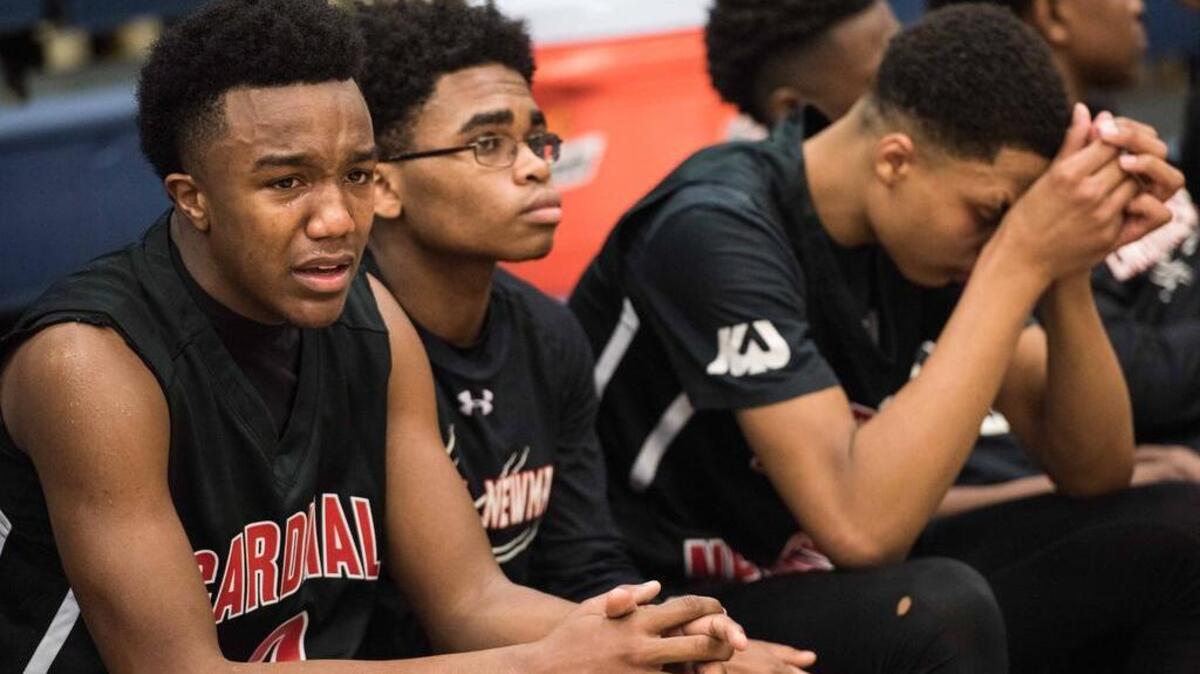 Cardinal Newman's Chico Carter Jr. and teammates react after the SCISA Class 3A state championship game against Porter-Gaud.