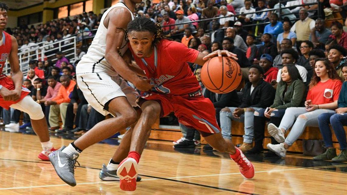 A.C Flora's James Reese (0) makes a drive to the bucket as Lower Richland's Ja'Cor Nelson (2)