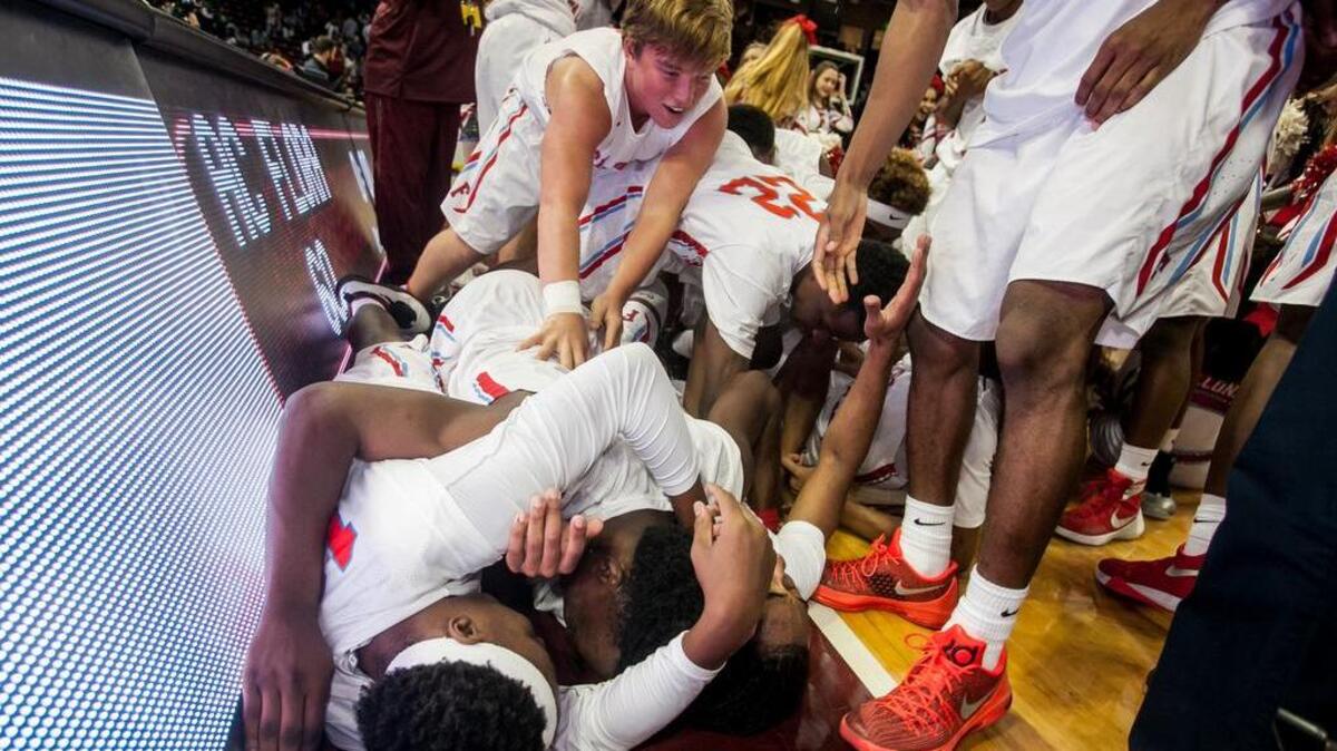 A.C. Flora High School players celebrate following their win over Midland Valley High School in the 3A Boys State Championship game.