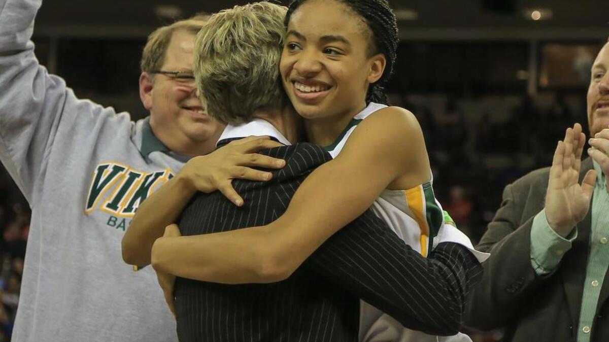Spring Valley’s Christian Hithe hugs coach Anne Long after winning the state championship in 2015.