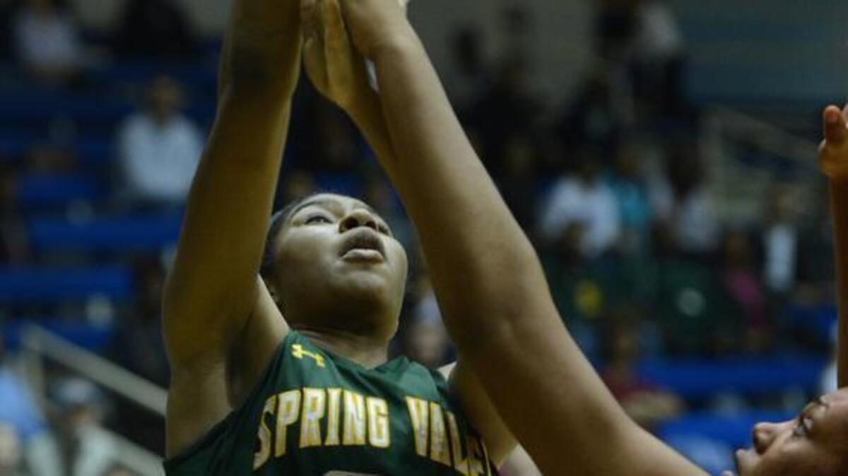 Spring Valley’s Shantay Taylor makes a shot over Dorman’s Alexis Johnson during the third round of the Class 4A playoffs.