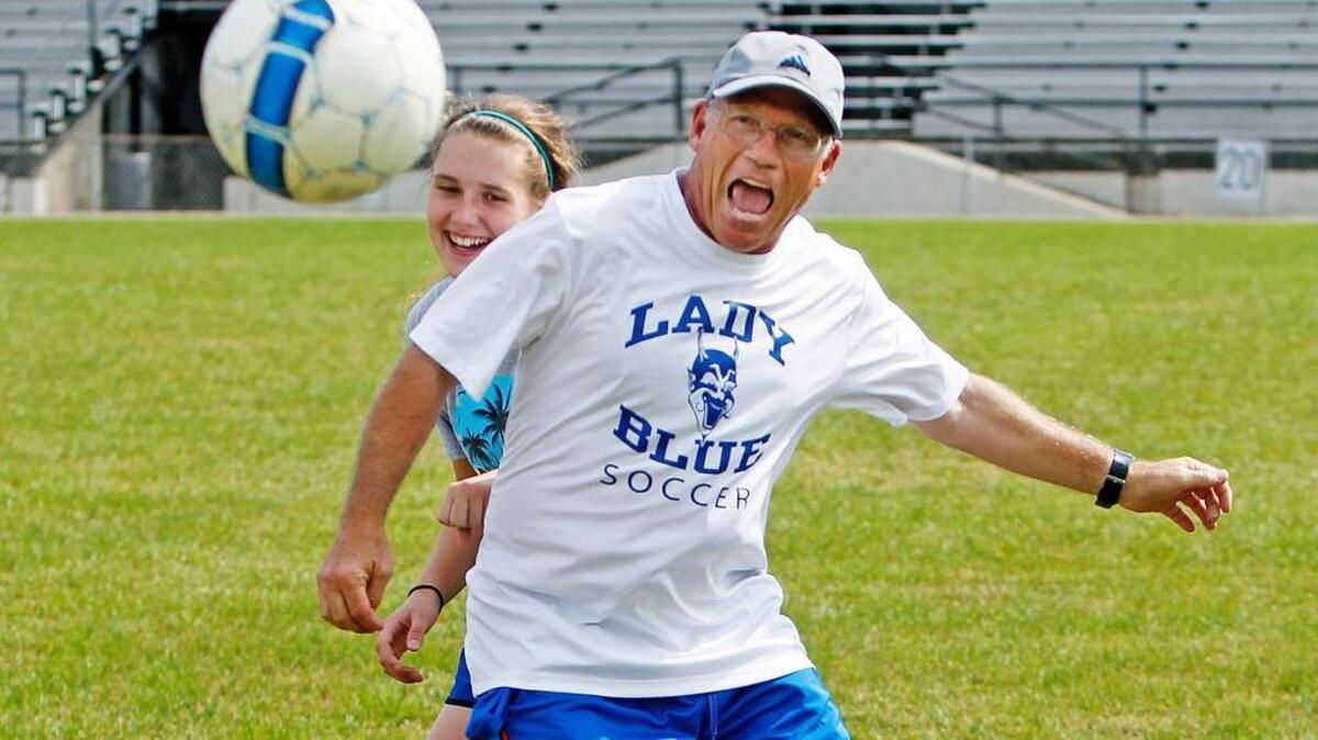 Dreher girls soccer coach David Kleinfelder joins a drill with Naomi Matthusen during practice, Thursday, May 14, 2015. Kleinfelder has been coaching soccer for almost 40 years. He'll get his first chance to play in a state championship game on Friday when Dreher plays against Hilton Head for the Class 3A girls title.