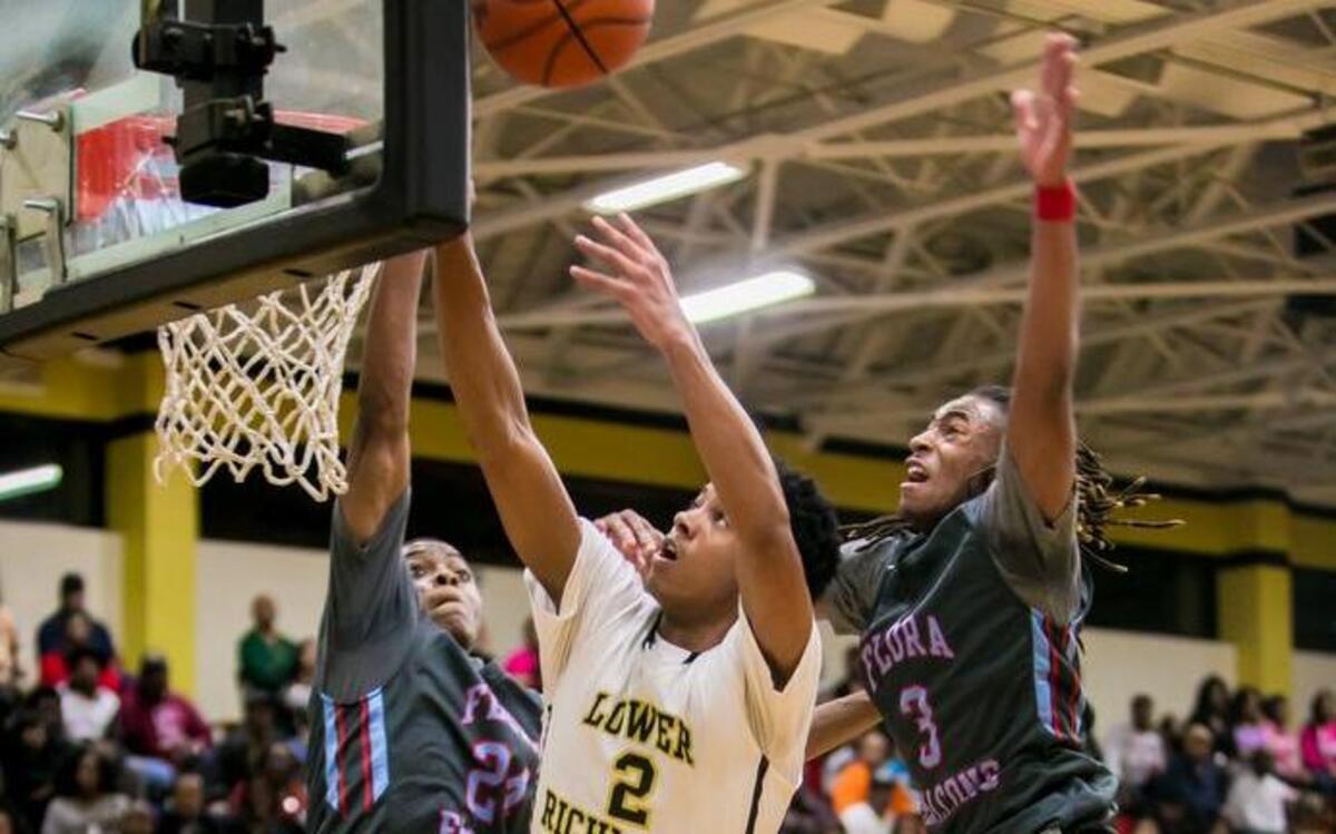 Lower Richland's Ja'Cor Nelson and AC Flora's Brandon Davis, left, and James Reese battle for a rebound during the game at Lower Richland High School.