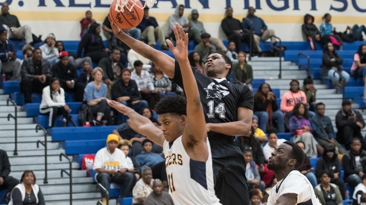 Gray Collegiate's KeShawn Shields (14) goes up for a bucket over Keenan defender Dillon Jones (11) earlier this season. The two top-ranked teams in the Midlands will have their rematch Friday at Allen University.