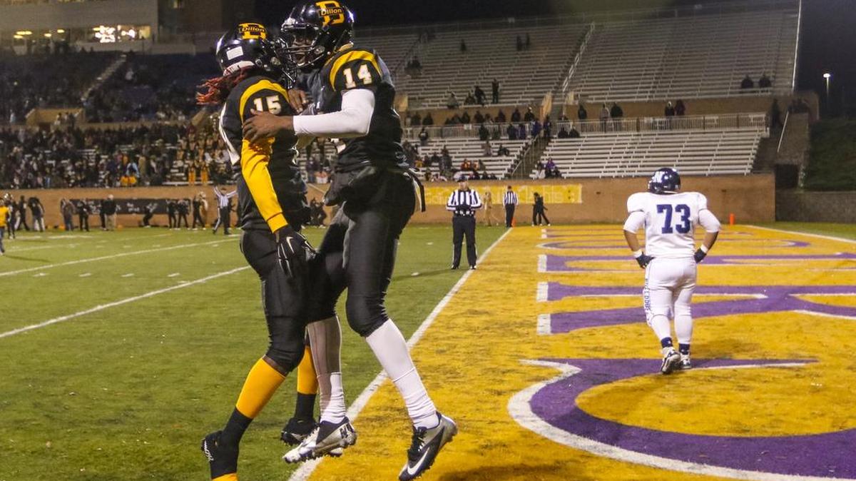 Dillon's Kanore Mckinnon (14) celebrates his touchdown against Newberry with teammate Dillon's Khw'dief Manning (15) during the Class 2A Division I state football championship game At Benedict College Friday.