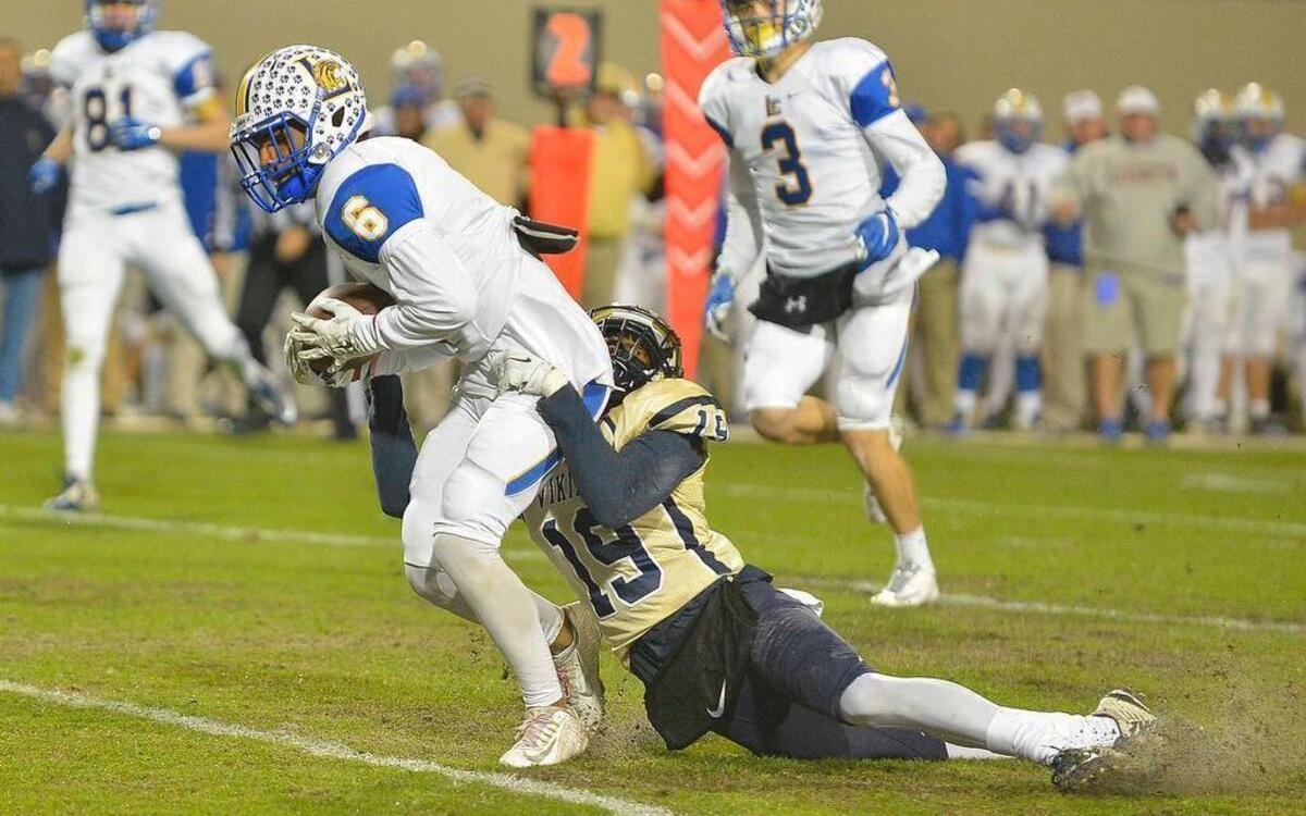 Lexington's (6) Oscar Ferguson gets tackled in the Wildcats’ game at Spartanburg High on Friday night.
