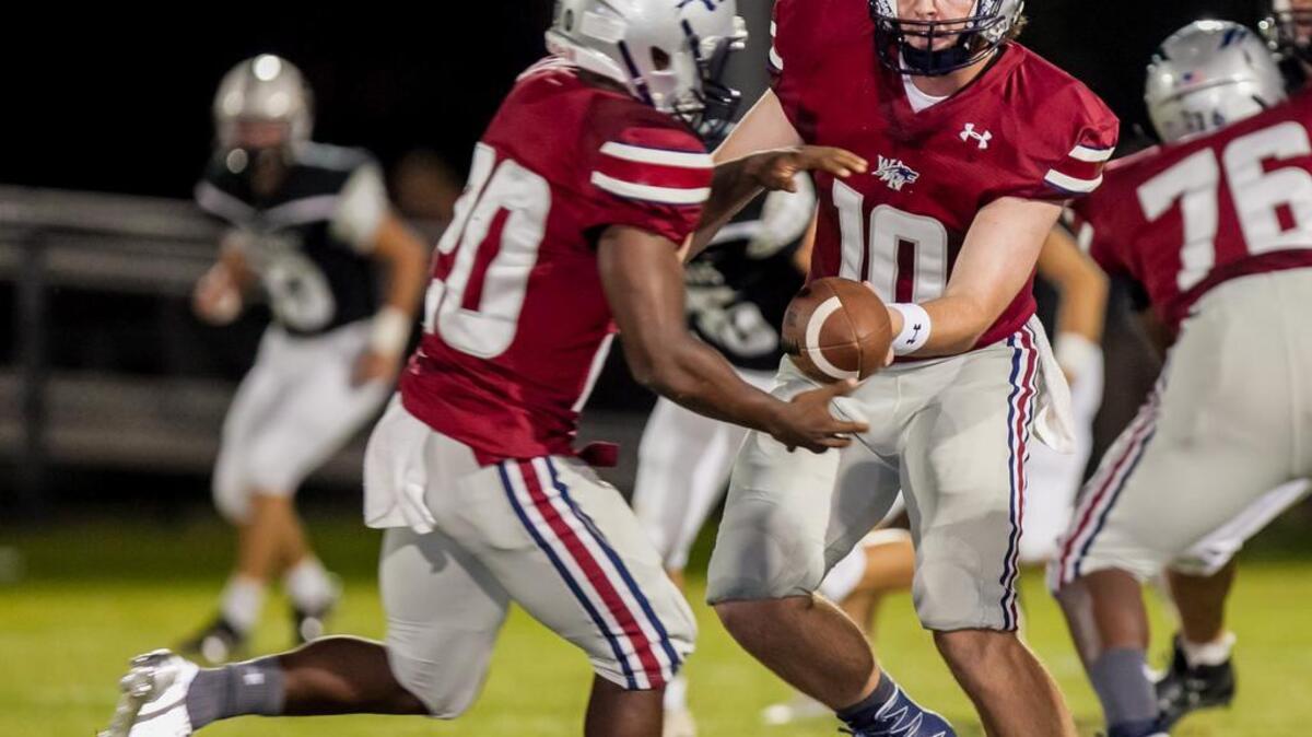 White Knoll quarterback Jacob Jeffcoat hands off to running back Maurice Jones during a scrimmage against Gray Collegiate at White Knoll High School. 8/12/16