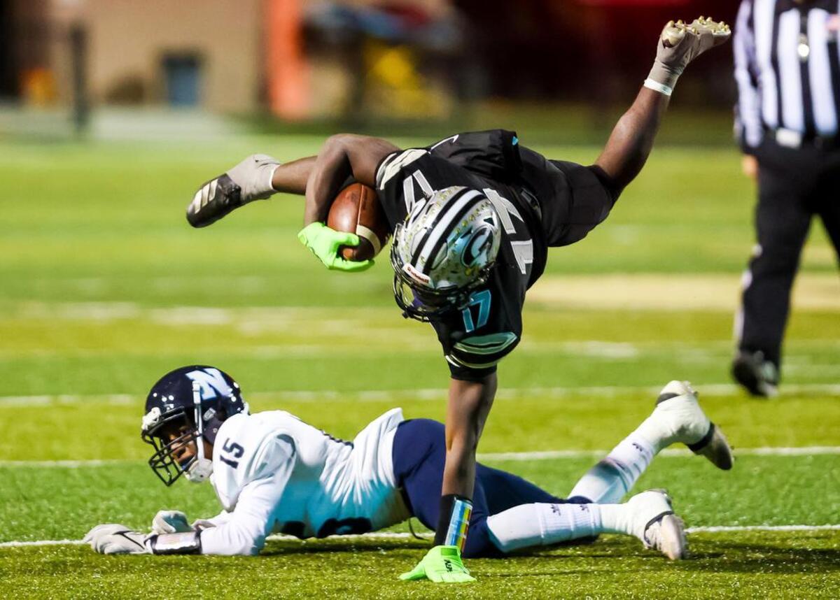 Gray Collegiate War Eagles KZ Adams (17) leaps o ver Newberry Bulldogs JaQuan Davis (15) in a playoff game Friday,&nbsp;Nov. 26, 2021 at Fairfield Central High School.