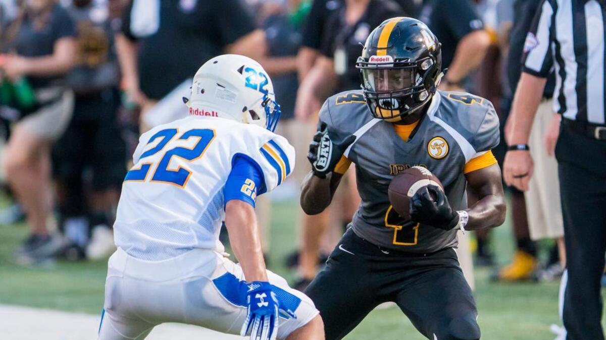 Irmo Yellowjackets Omarion Dollison (4) looks to get around a Lexington Wildcats defender during the game between Lexington High School and Irmo High School at Irmo High School