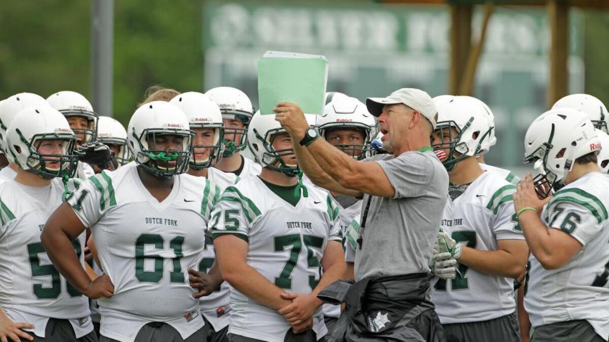 Dutch Fork High football coach Tom Knotts, a former coach at Independence High in Charlotte, gives out instructions to his offense during practice.