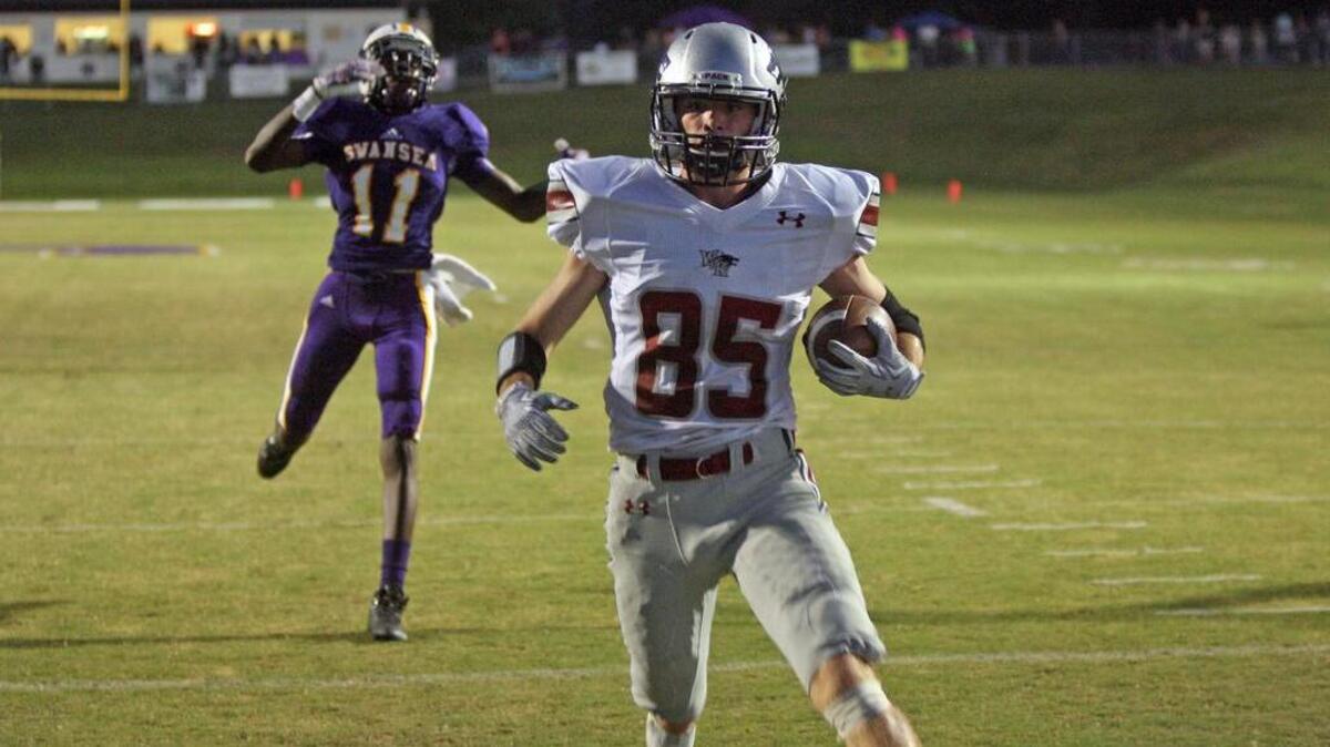
White Knoll receiver Bruce Wilkinson scores a touchdown in the Timberwolves’ win over Swansea on Friday night.
