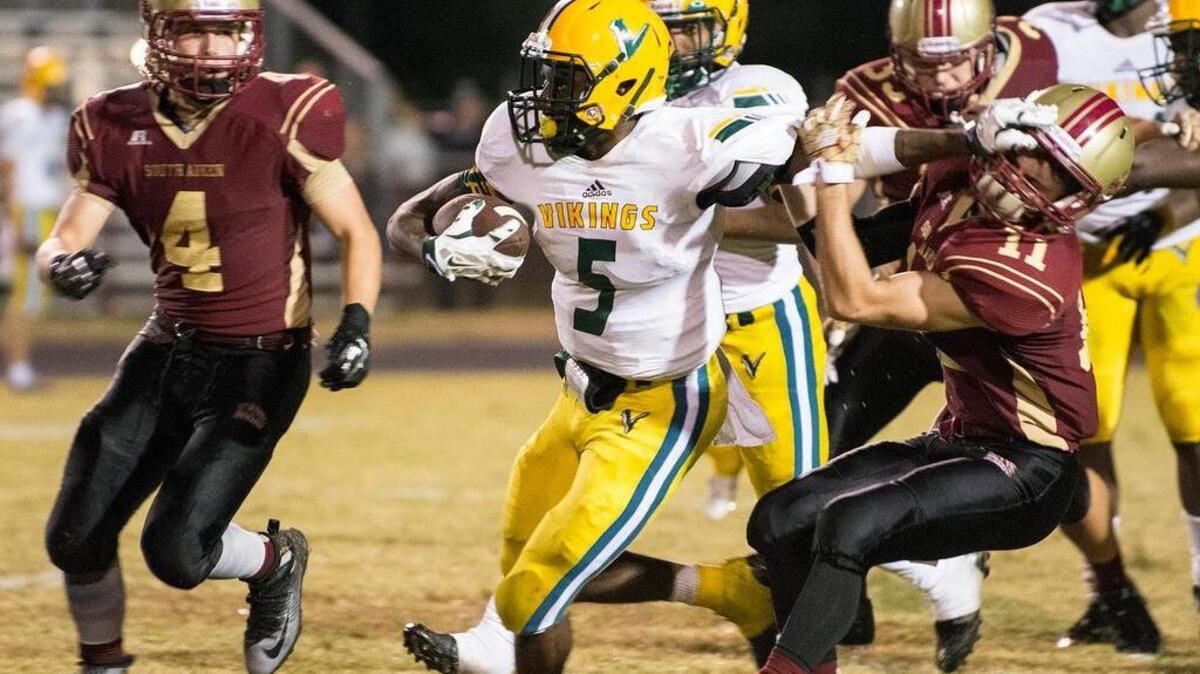 
Ty’Juan Fulton (5) of Spring Valley fights off South Aiken defender Eli Bentley (11) as he runs for a gain on Friday night.
