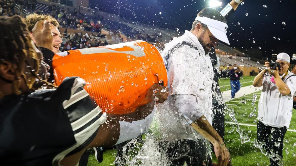Gray Collegiate War Eagles head coach Adam Holmes is dunked with Gatorade in celebration of their win in the Class 2A SC State Championship Game at Benedict College in Columbia, SC, Friday night, December 3, 2021.